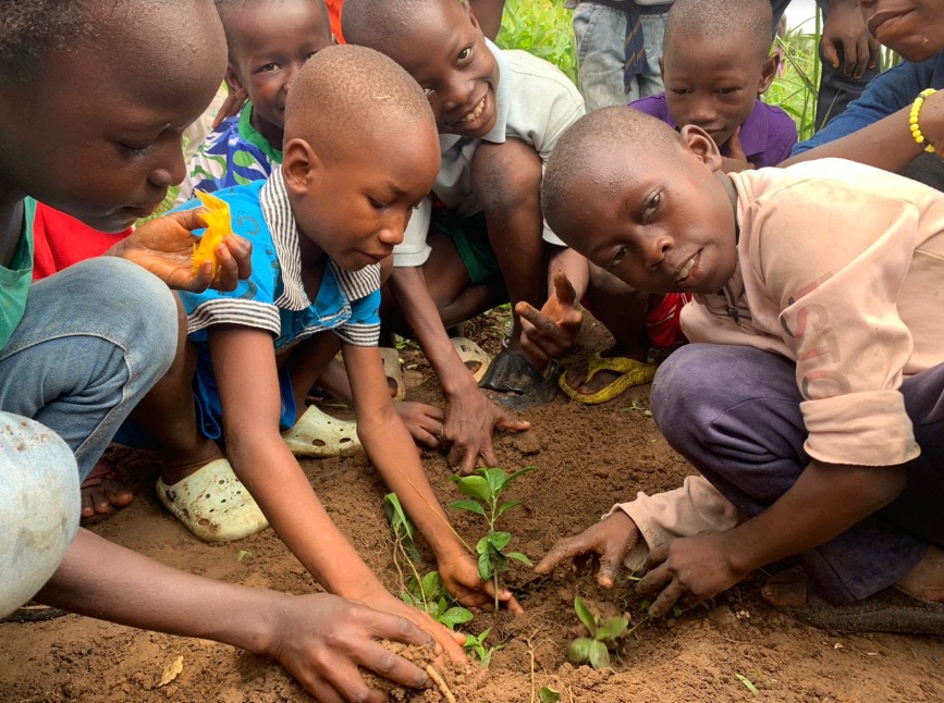 Children of SHARP planting trees